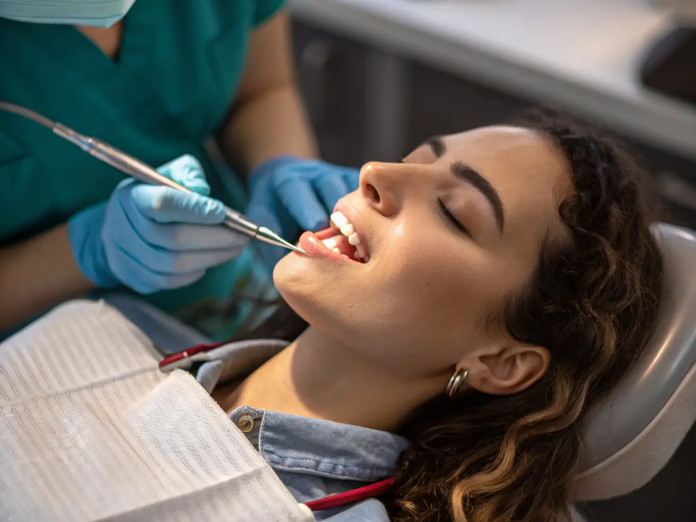 A dentist performing a cosmetic dentistry procedure, such as applying veneers, with a focus on enhancing the patient's smile.